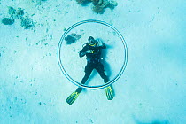 Dive instructor Ahmed Gomaa blows bubble rings whilst scuba diving at dolphin house reef, northern Red Sea, February 2016
