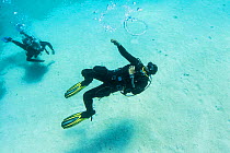 Dive instructor Ahmed Gomaa blows bubble rings whilst scuba diving at Dolphin House Reef, northern Red Sea, February 2016.