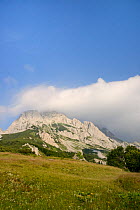 Adiabatic banner clouds forming above the 2386m peak of Mount Maglic, Bosnia's mountain, as warm air rises, cools and is blown by the wind, Sutjeska National Park, Bosnia and Herzegovina, July 2014.
