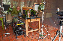 Photographer Stephen Dalton with his  indoor studio set up for insect flight photography of Speckled Wood butterfly (Parage aegeria) September 2015