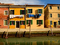 View along canal and buildings of Burano, one of the islands on the lagoon, Venice, Italy