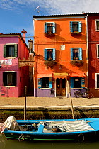 View of boat on canal and buildings on Burano, one of the islands on the lagoon, Venice, Italy