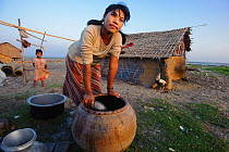 Rakhine girl washing up after a day of subsistence shellfish collecting on an ephemeral barrier island in the Bengal Sea, Rakhine State, Myanmar, 2012