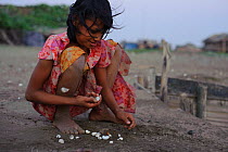 Rakhine girl playing a shell game on Nan Tahr Island, Myanmar 2012