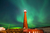 Northern lights showing above Andenes Lighthouse, Andenes, Andoya island, North Atlantic Ocean, Norway January 2016