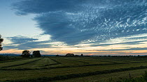 Sunset timelapse, with recently mowed hay in fields, Somerset, England, UK, September 2013.