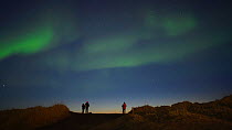 Time-lapse of people watching and photographing the Aurora Borealis, seen from Seltjarnarnes, Reykjavik, Iceland. April 2016