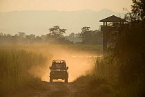 Tourist vehicle on game drive, Kaziranga National Park, Assam, North East India. November 2014.