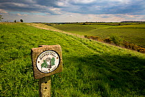 Gloucestershire Wildlife Trust (GWT)  Nature Reserve sign on the Pasqueflower reserve,  a dry valley, Gloucestershire, UK. April 2015.