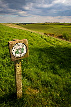 Gloucestershire Wildlife Trust (GWT)  Nature Reserve sign on the Pasqueflower reserve,  a dry valley, Gloucestershire, UK. April 2015.