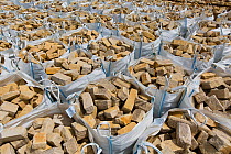 Dressed limestone building material in tonne bags, Huntsmans Quarry, Naunton, Gloucestershire, UK. July.