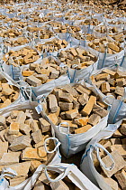 Dressed limestone building material in tonne bags, Huntsmans Quarry, Naunton, Gloucestershire, UK. July.