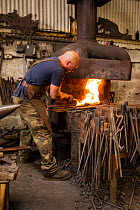 A rural blacksmith at work, Cherington Forge, Cherington, Gloucestershire, UK. September 2015.