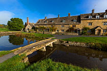 Cotswolds village of Lower Slaughter with stone clapper bridge, Gloucestershire, UK. October 2015.