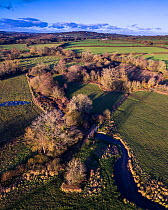 River Eye flowing through water meadows on Greystones Farm Nature Reserve, Site of Special Scientific Interest (SSSI), Gloucestershire Wildlife Trust. The River Eye is home to a large water vole popou...