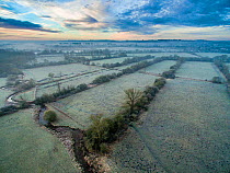 River Eye flowing through water meadows at Greystones Farm Nature Reserve, Site of Special Scientific Interest (SSSI). Gloucestershire Wildlife Trust, Bourton-on-the-Water, Gloucestershire, UK. Shot b...