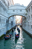 Gondolas with tourist passengers at the Bridge of Sighs, Venice, Italy, April.