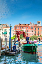 Maintenance barge repairing mooring posts on Grand Canal, Venice, Italy.