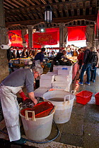 Traders and customers in Rialto fish market, Venice, Italy, April.