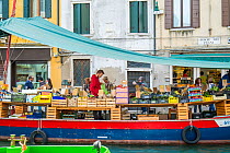 Barge selling fruit and vegetables, Rio de Santa Barnaba, Venice, Italy, April.