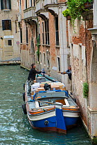 Deliveries by canal barge Venice, Italy, April.