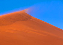 Top of sand dune with wind blowing sand, Namib Naukluft National Park, Namibia
