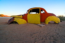 Deserted car half sunk in sand, Solitaire, Namib Naukluft National Park, Namibia 2015