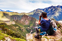 Woman admiring view from the Sun Gate, Inca Trail, Peru. December 2013.