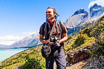 Photographer hiking W Trek, Torres del Paine National Park, Patagonia, Chile. January 2014. Model released.