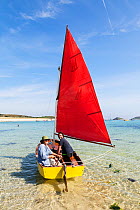 Man and woman sailing a mirror dingy, St.Martin's, Isles of Scilly, England. August 2013. Model released.