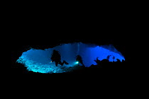 Diver in a cave called 'Turtle Cove' - a narrow entry of the cave where sometimes turtle enter and get lost inside - Koror, Palau, Philippine Sea