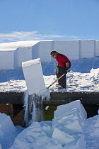 Jeff Henry clearing snow from roofs at Canyon Village. Yellowstone National Park, Wyoming, USA. January