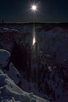 Moon beam at full moon over the Grand Canyon of the Yellowstone, Yelllowstone National Park, Wyoming, USA. January 2016.