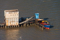 Aerial view of loading sugar on barge to export, coastal Guyana, South America
