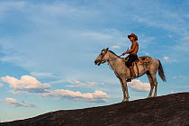 Amerindian cowboy on horseback, Rurununi savanna, Guyana, South America