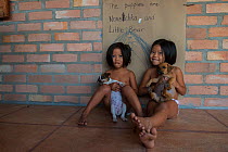 Two children holding domestic dogs, Rupununi, Guyana, South America