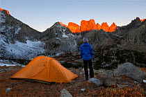 Sunrise over campsite in Cirque Of Towers area, Popo Agie Wilderness, Wind River Range, Shoshone National Forest, Wyoming, USA. September 2015. Model released.