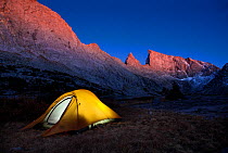 Tent lit up from inside, camping  in  Bridger Wilderness area of Wind River Range, Bridger National Forest, Wyoming, USA. September 2015.