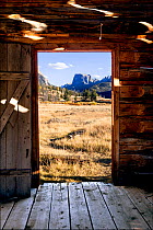 View through doorway of Osborn Cabin of Squaretop Mountain in Green River Valley, Bridger National Forest, Wyoming, USA. September 2015.