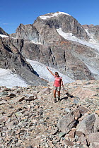 Hiker on Dinwoody Pass nearTitcomb Basin in Wind River Range, Bridger Wilderness, Bridger National Forest, Wyoming, USA. September 2015. Model released.