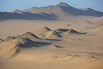 Aerial view of Nazca coastal desert with sand dunes in Paracas National Reserve, Peru