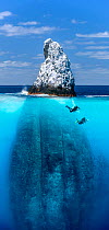 Roca Partida above and below sea level with divers  -  a small rock island covered in white bird guano  in the Revillagigedo Archipelago Biosphere Reserve, Socorro Islands, Western Mexico. Composite s...