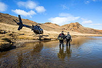 Heli-diving, going into the water for a scouting scuba dive in a mountain lake, Iceland