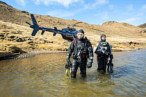 Heli-diving, going into the water for a scouting scuba dive in a mountain lake, Iceland