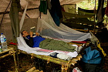 Expedition members resting at camp in the Arfak Mountains at 2000 m.West Papua, New Guinea. November 2009.