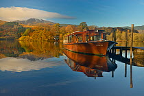 Boat moored at jetty in autumn on Derwent Water, Keswick, Lake District, Cumbria, England, UK. November 2013.