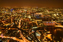 Aerial view of River Thames and London, lit at night, England, UK. October 2014.