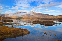 Clouds, mirror reflections and mist clearing Mountains on Loch nah Achlaise on Rannoch Moor in the Highlands, Scotland, UK. April 2011.