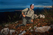 Photographer Laurent Geslin, testing his camera trap at night, Swiss Alps, Switzerland, October 2013.