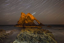 Bowfiddle rock arch with star trails in sky, Portknockie, Moray, Scotland, UK, August 2015.